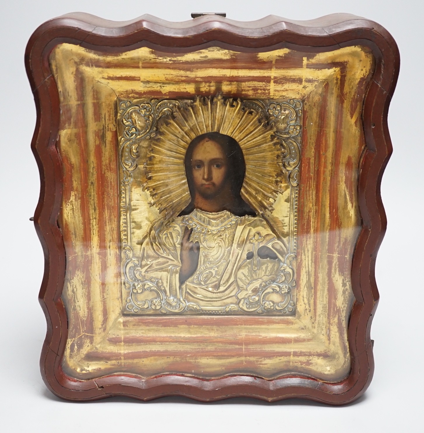 A late 19th- early 20th century Russian icon, in case, 28cms high x 25cms wide in total